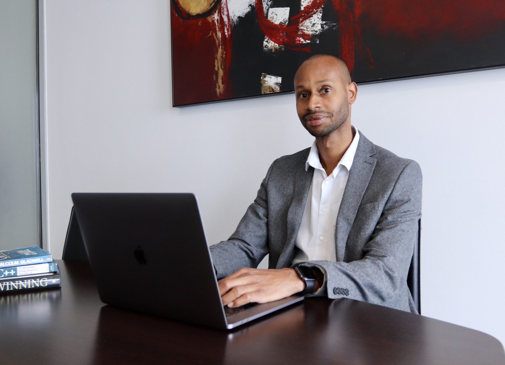 Andre Barrett, founder of Software Startup Academy, working on a laptop